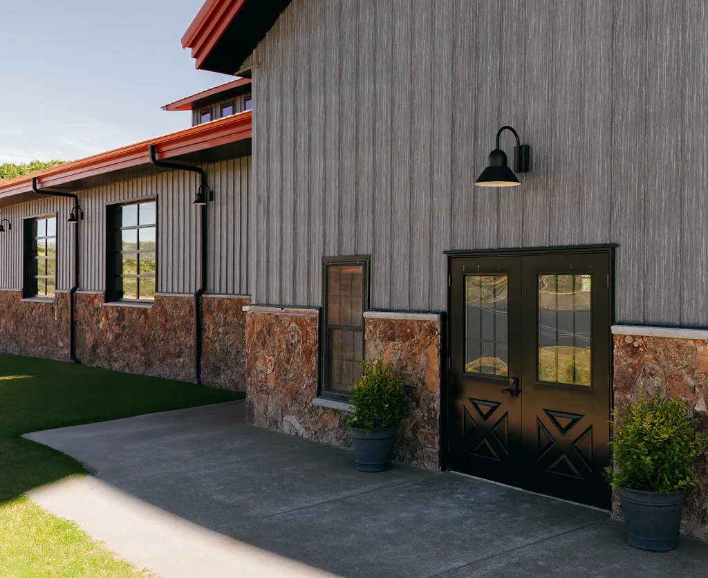 Exterior entrance to the modern horse barn at SkyRidge Equestrian.
